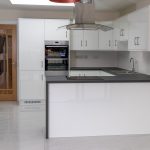 Kitchen area with electric controlled flat roof window, high gloss kitchen units and high gloss tiles