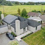 Exterior of the property with the lean-to roofs with natural slate on all higher sections of the building